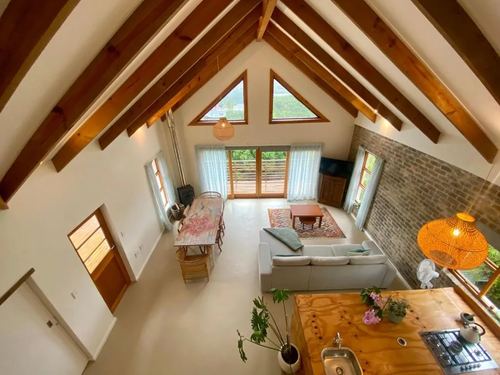 Bright loft space with vaulted wooden beams and comfortable seating