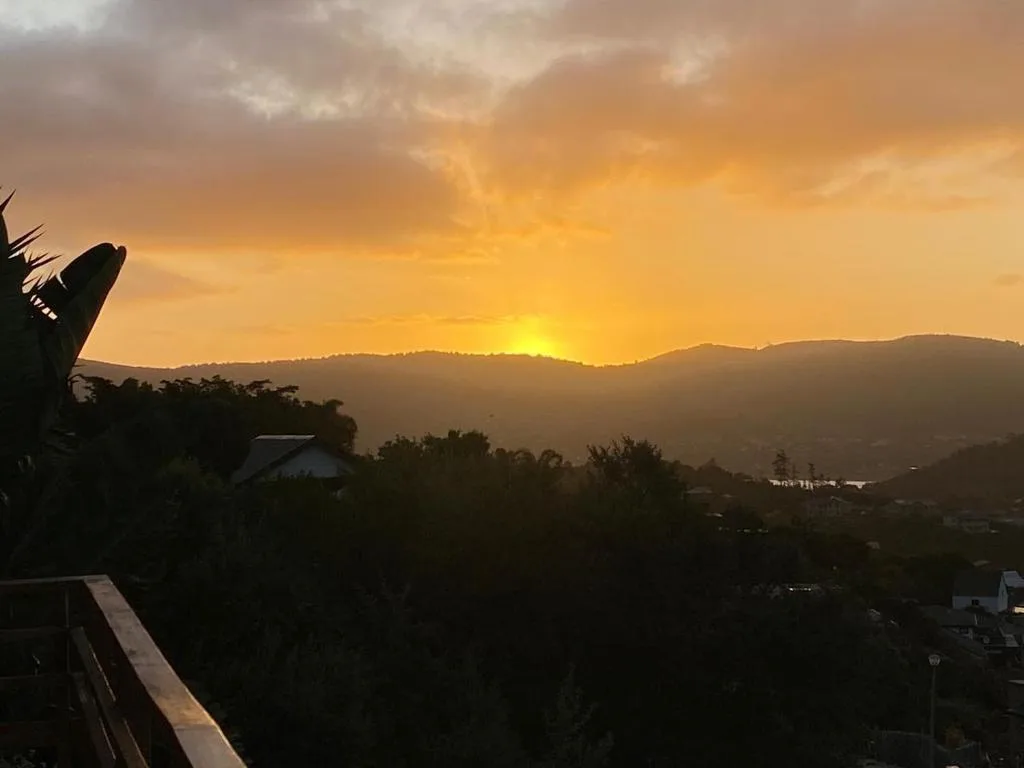 Golden sunset over forested mountains and valley landscape
