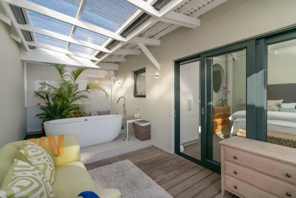 Modern bathroom with freestanding white tub and skylight windows overhead
