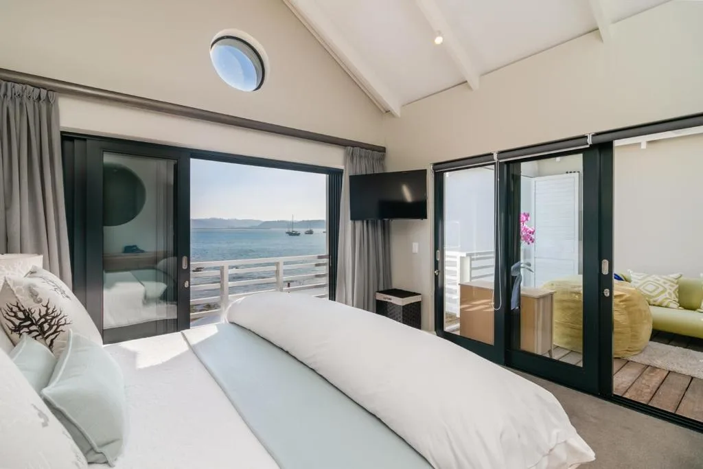 Spacious bedroom with ocean views and direct deck access