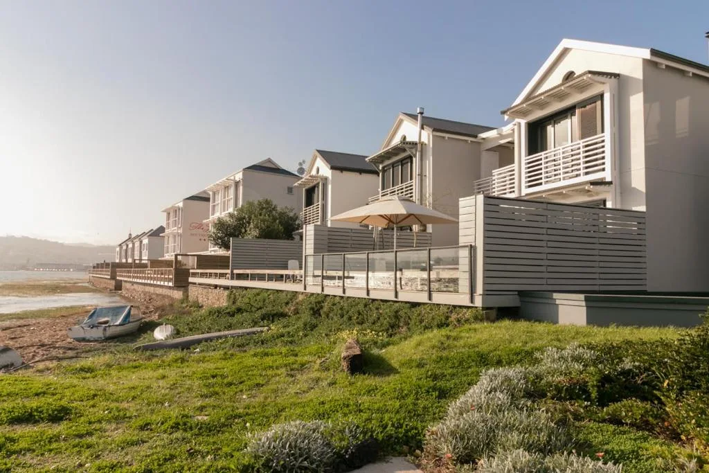 Modern beachfront villa with deck and landscaped gardens facing lagoon
