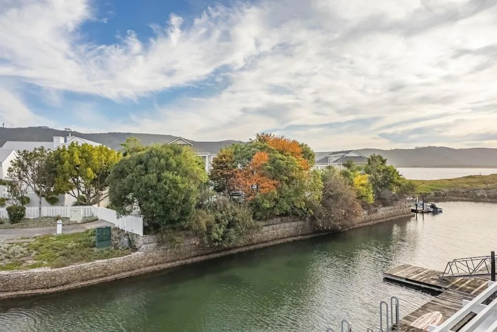 Waterfront property with lagoon views, boats, and distant hills