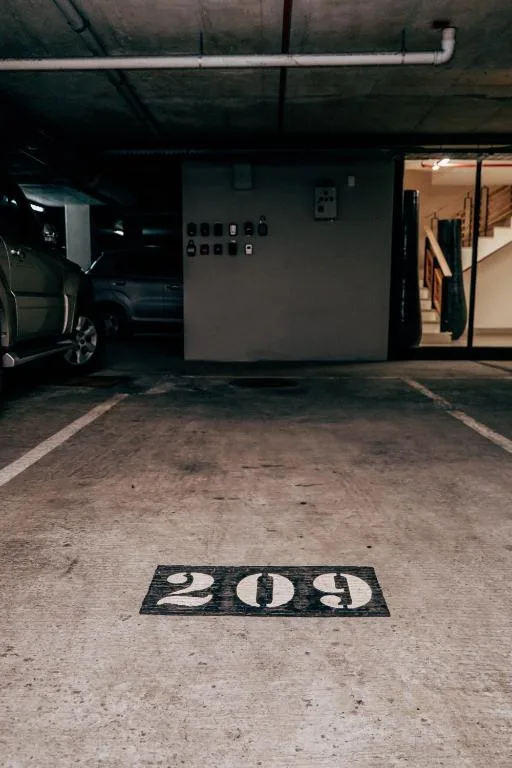 Numbered parking space 209 in secure covered garage area