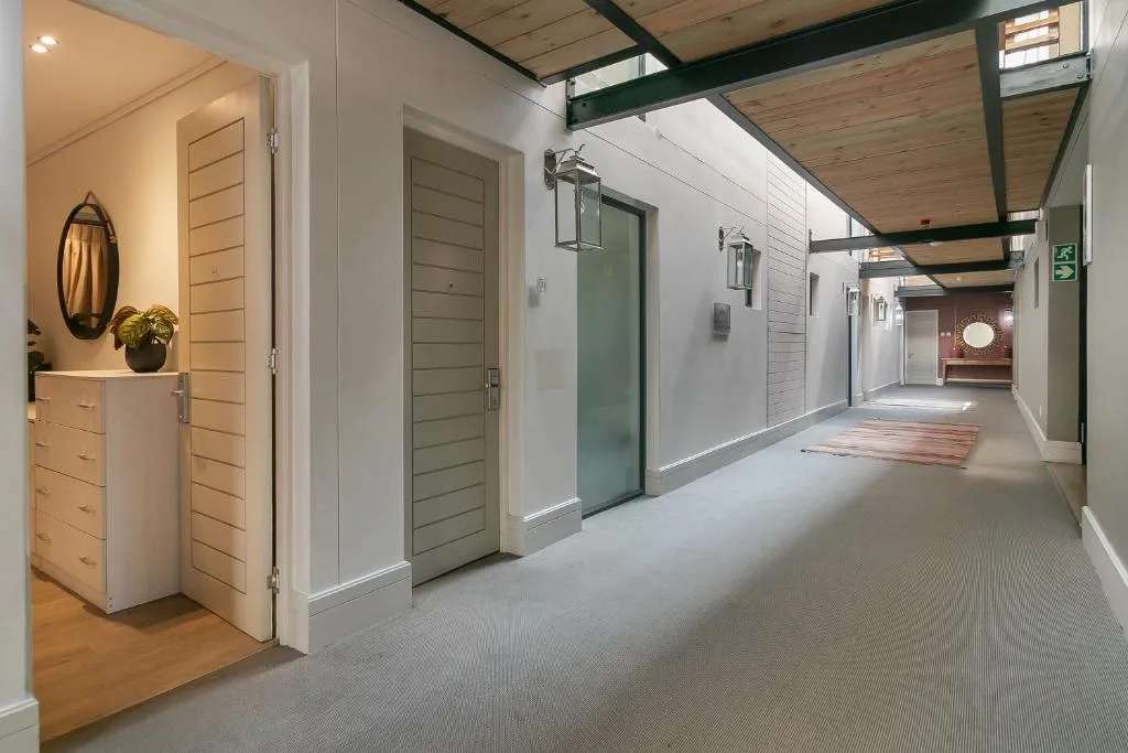 Modern interior hallway with wooden doors and contemporary lighting fixtures