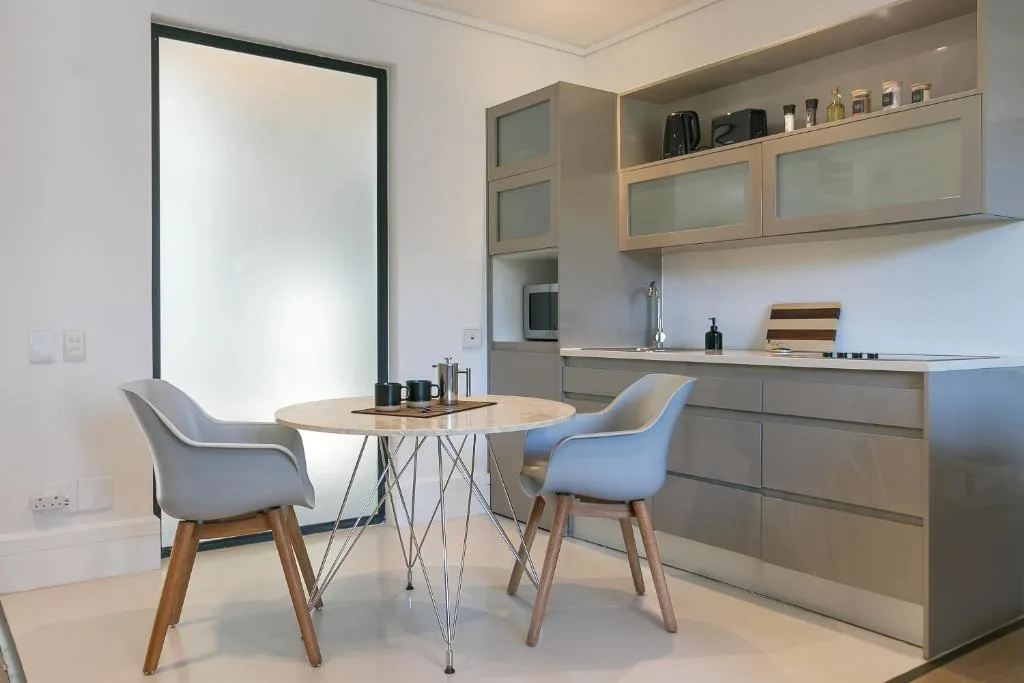 Modern kitchen with dining table, cabinetry, and stainless steel appliances