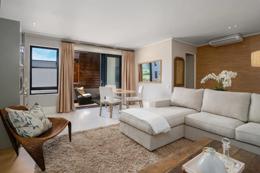 Spacious lounge with cream sectional sofa and modern furnishings