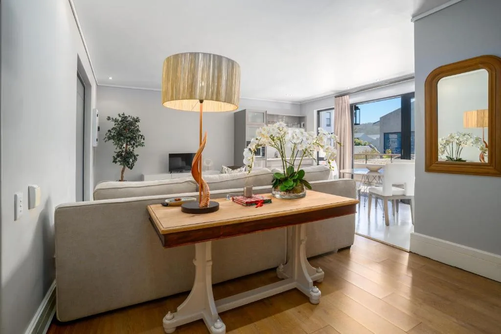 Modern lounge with cream sofa, wooden side table, and stylish pendant lamp