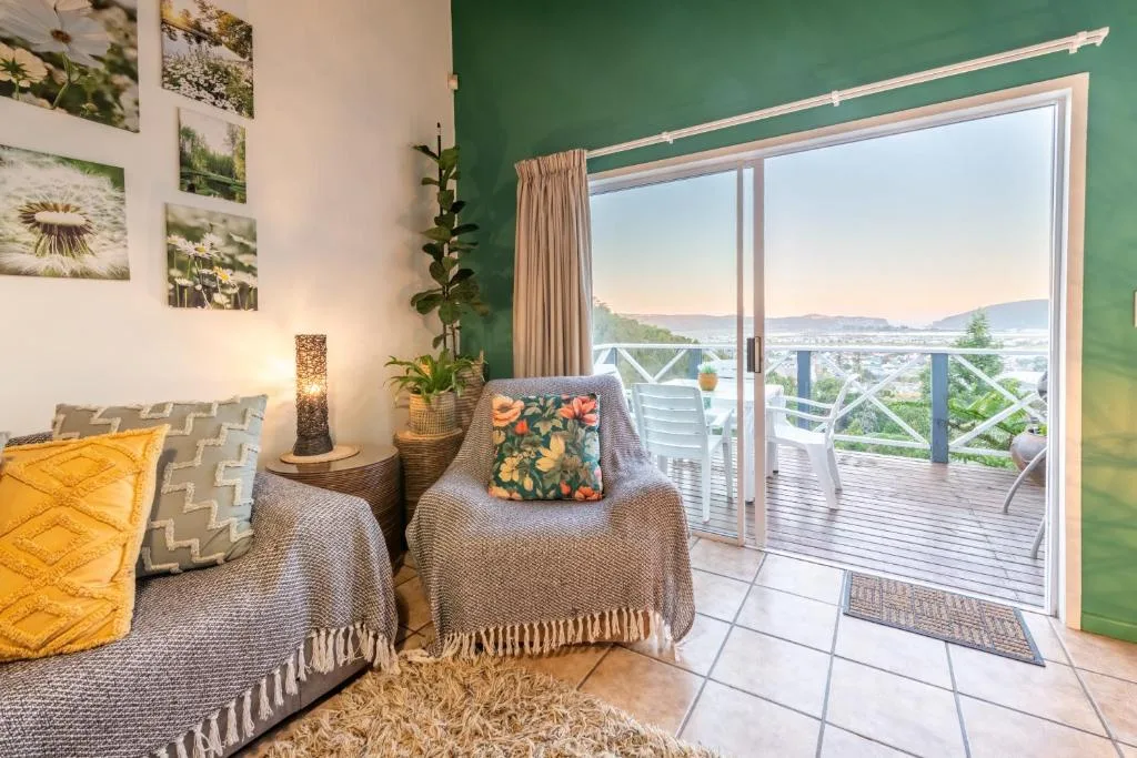 Stylish lounge with lagoon views through sliding glass doors to deck