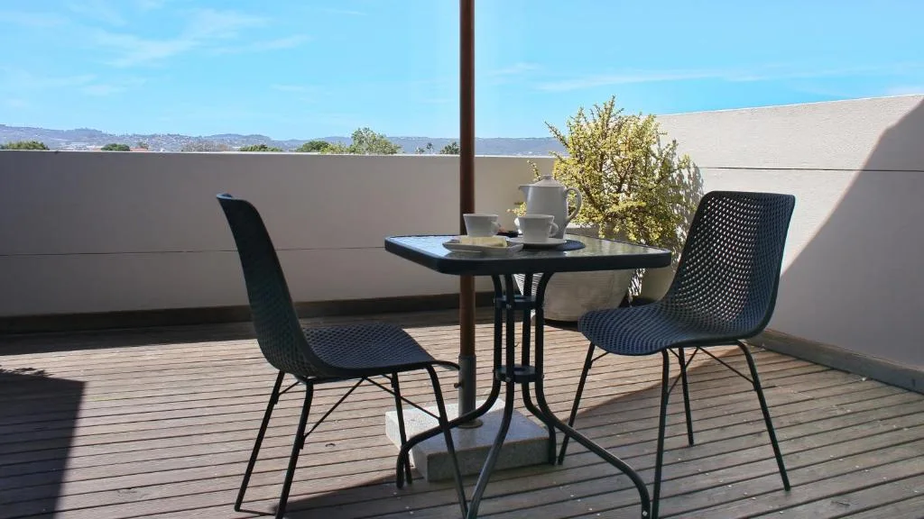 Outdoor patio with table, chairs, and mountain views beyond