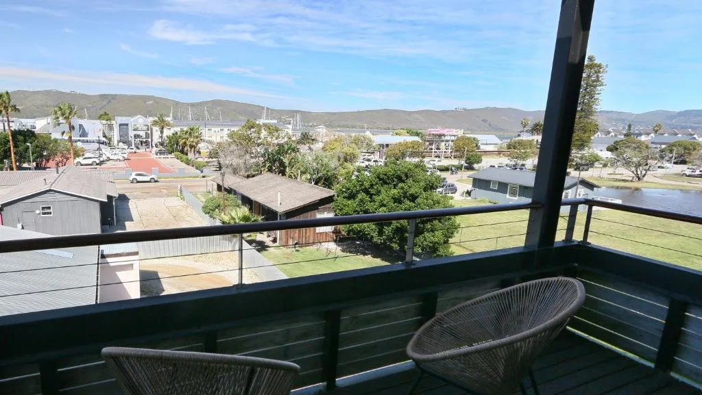 Panoramic town and mountain views from elevated deck with seating
