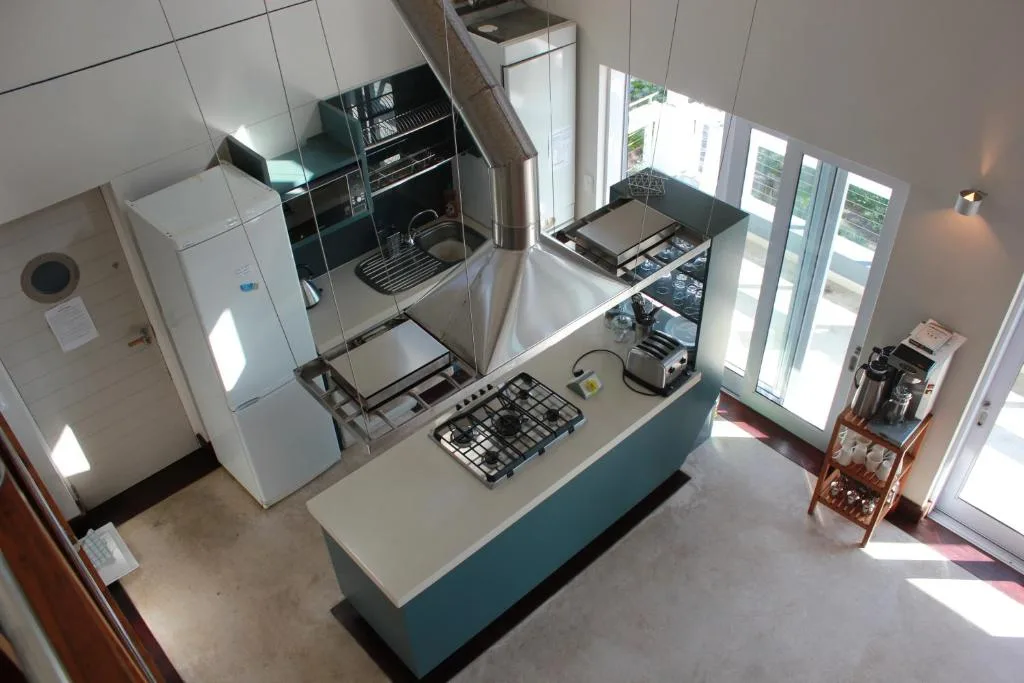 Modern open-plan kitchen with stainless steel appliances and natural light