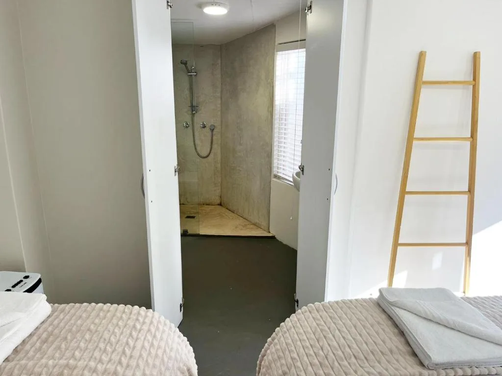 Modern walk-in shower with glass enclosure and rainfall showerhead