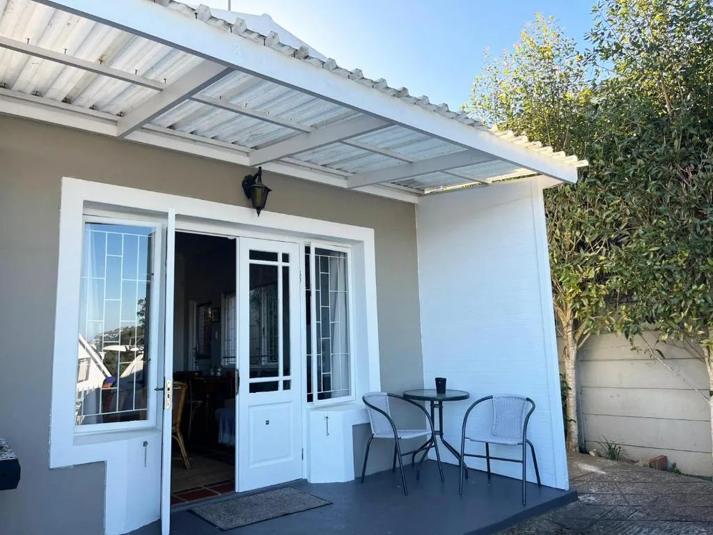 Covered outdoor patio with seating area and glass doors to interior