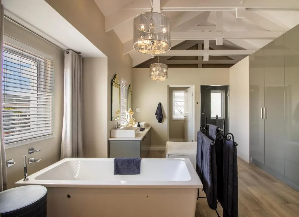 Luxurious bathroom with freestanding tub, double vanity, pendant lighting