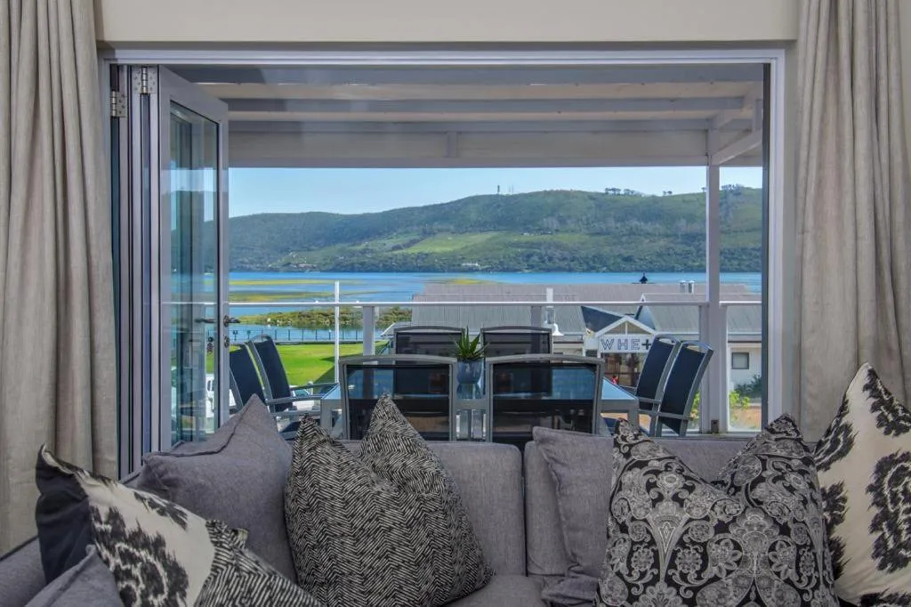 Scenic lagoon and mountain vista through large glass doors from lounge