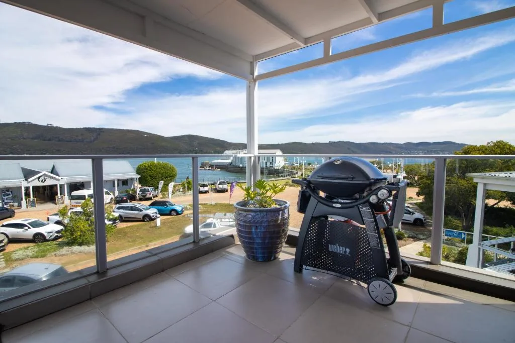 Scenic Knysna lagoon and hillside vista from covered waterfront deck