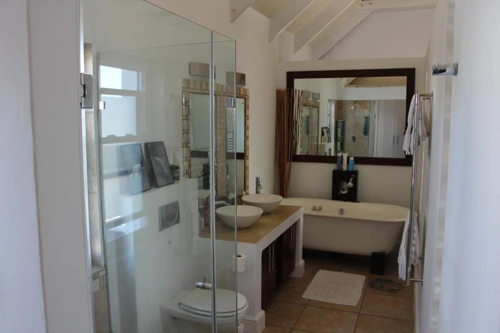 Modern bathroom with walk-in shower, double vanity, and freestanding bathtub