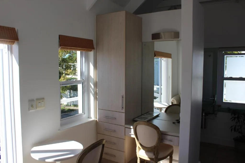 Modern bedroom workspace with built-in wardrobe and vanity desk