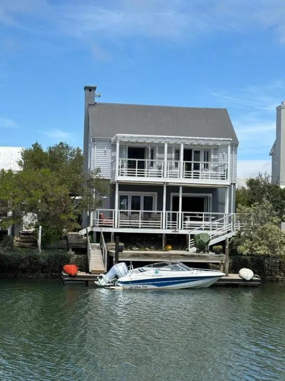 Waterfront holiday home with private jetty and moored speedboat