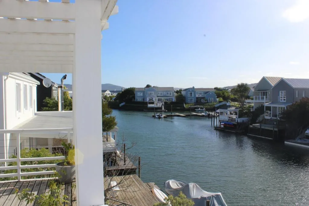 Scenic waterfront view of Thesen Island canal with residential homes and boats