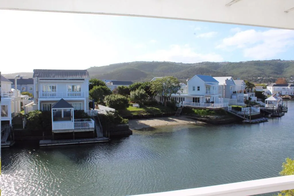 Waterfront homes with lagoon views and green hills beyond