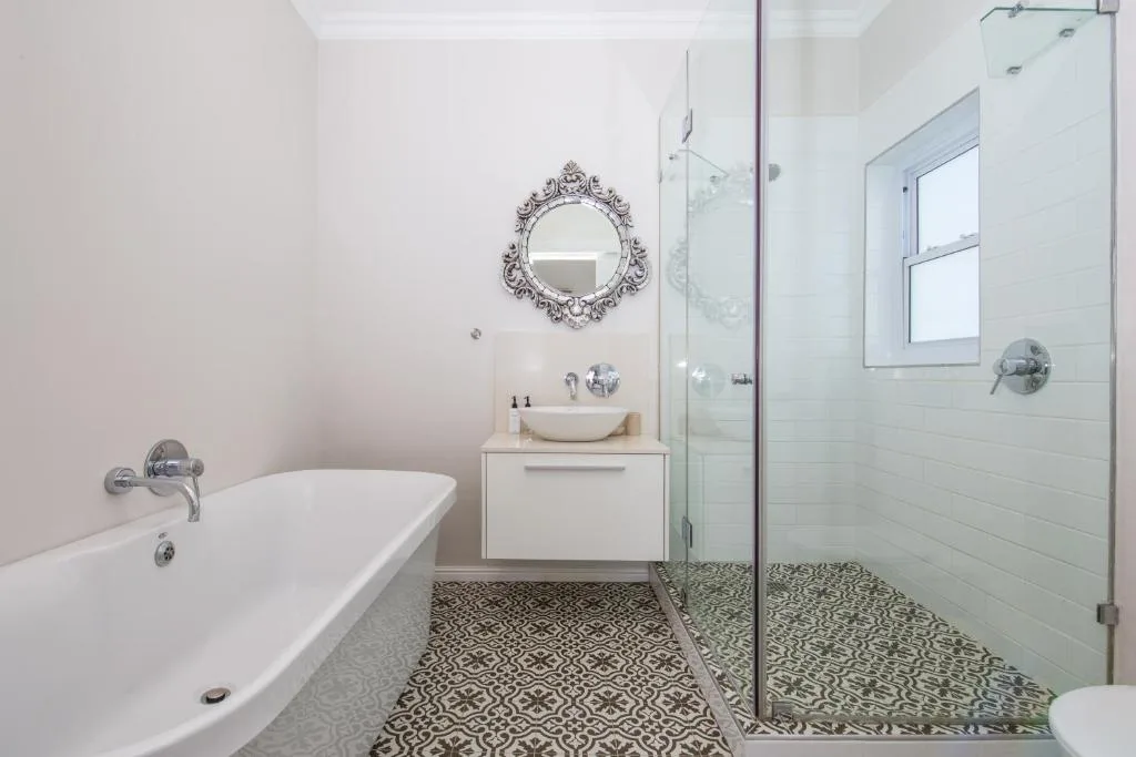 Modern bathroom with freestanding tub, vessel sink, and walk-in shower