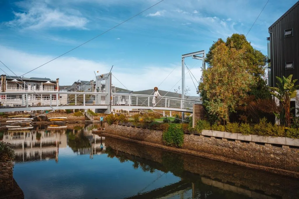 Waterfront holiday home with bridge over calm lagoon water