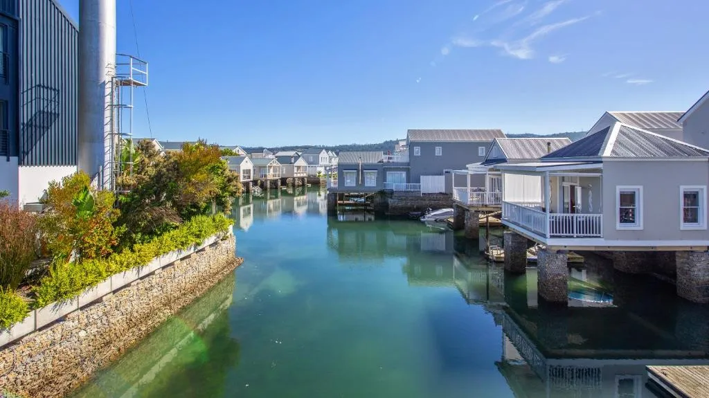 Waterfront village with colorful homes and calm lagoon reflections
