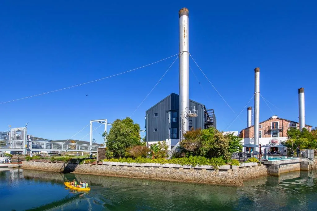 Waterfront view of Thesen Island with converted industrial buildings and boats