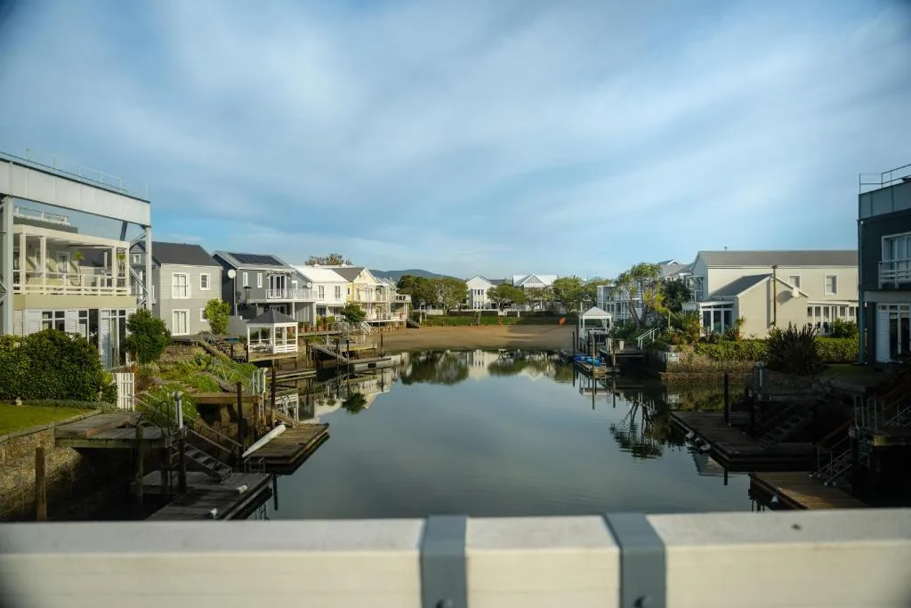 Waterfront lagoon with colorful houses and wooden jetties lining the water