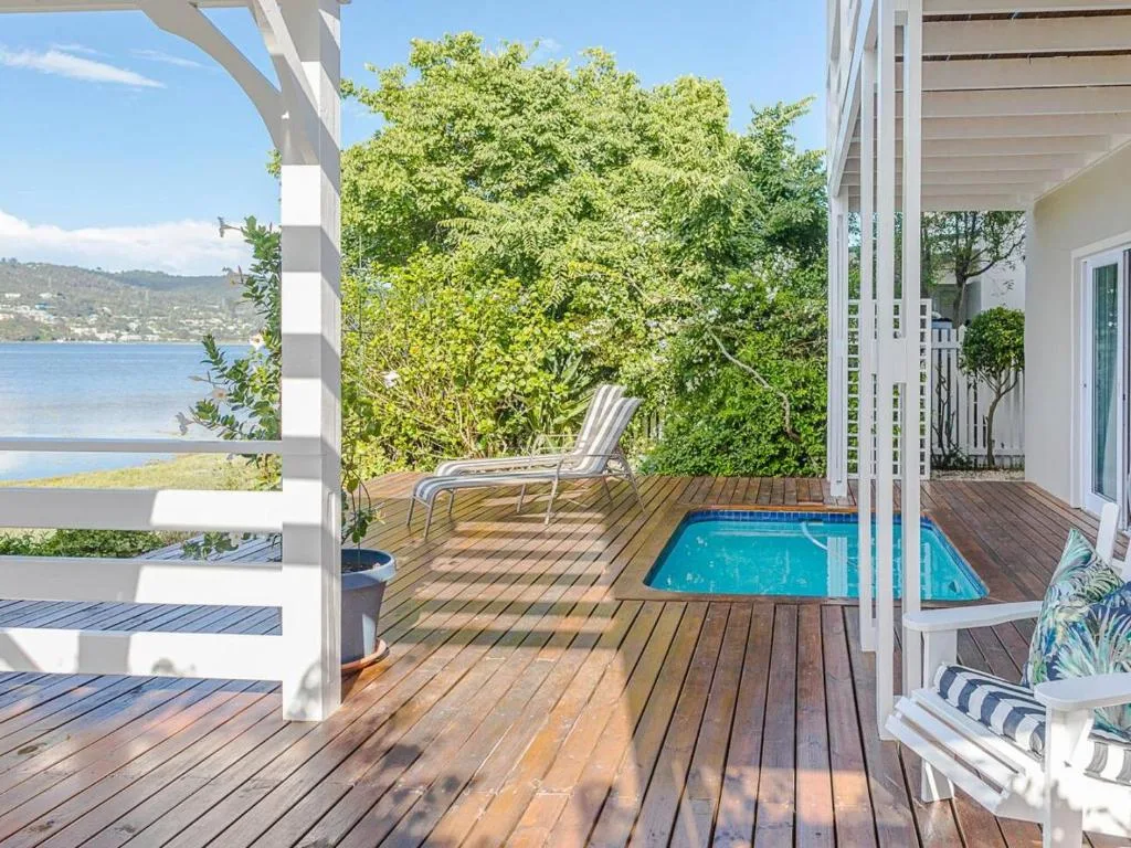 Wooden deck with small plunge pool overlooking Knysna Lagoon and mountains