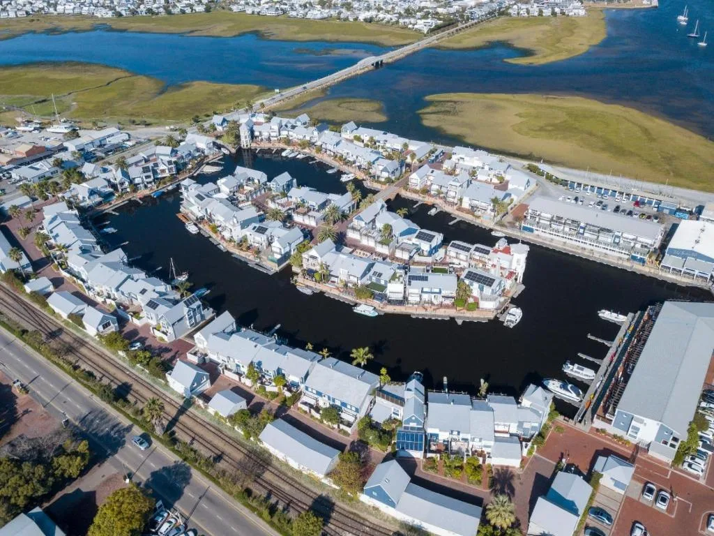 Aerial view of Knysna Quays waterfront with lagoon and moored boats