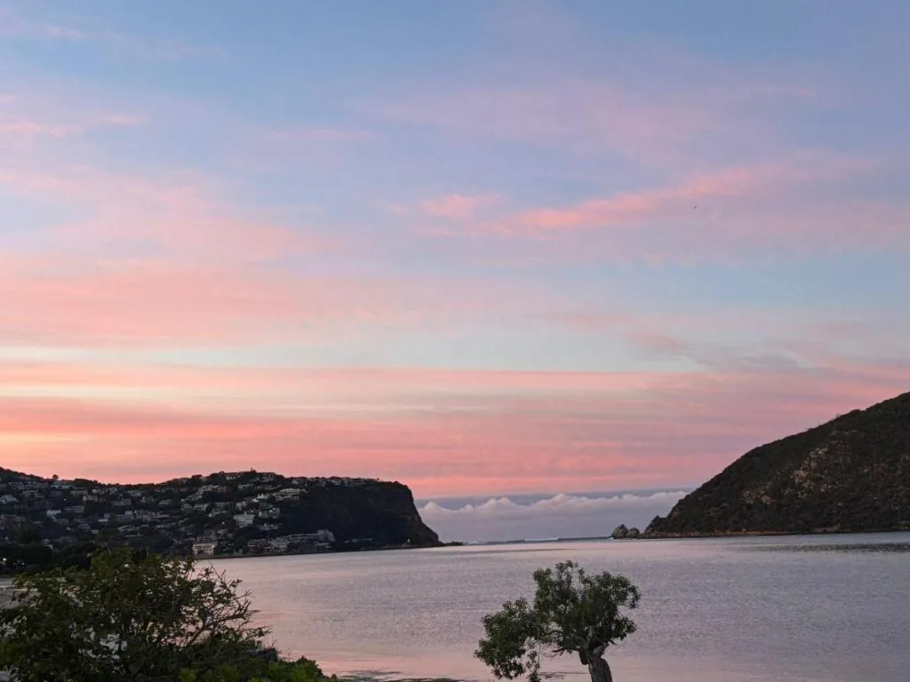 Stunning sunset over Knysna Lagoon with dramatic pink and purple sky