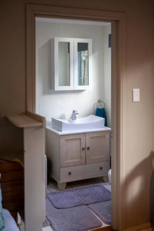 Modern bathroom with white vanity sink and mirrored medicine cabinet