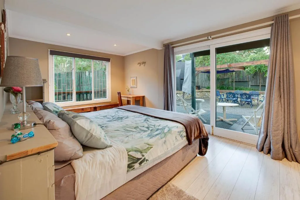 Spacious bedroom with king bed, garden views through sliding doors