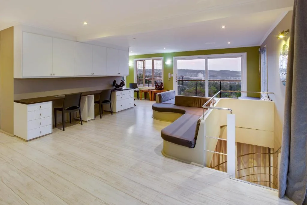 Modern lounge with seating and mountain views through large windows