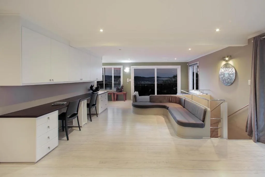 Modern lounge with curved seating and ocean views through large windows