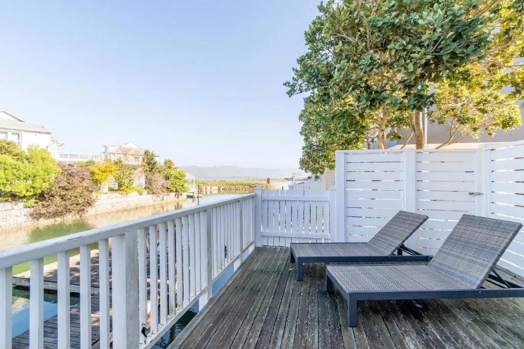 Waterfront deck with lounge chairs and lagoon views