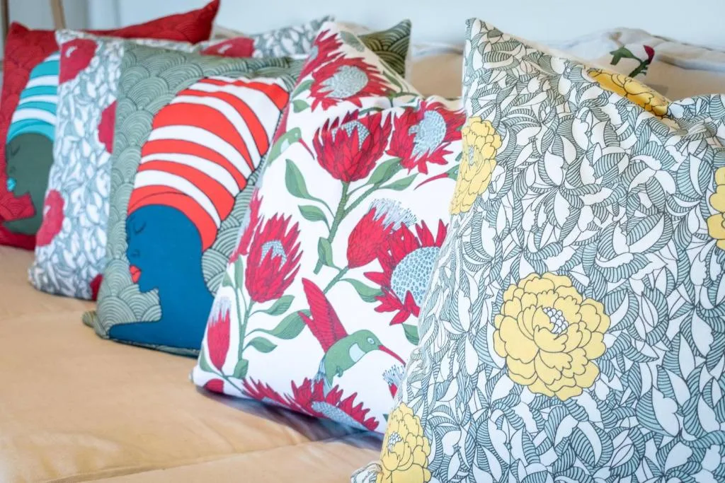 Colorful decorative pillows with floral patterns on a bed