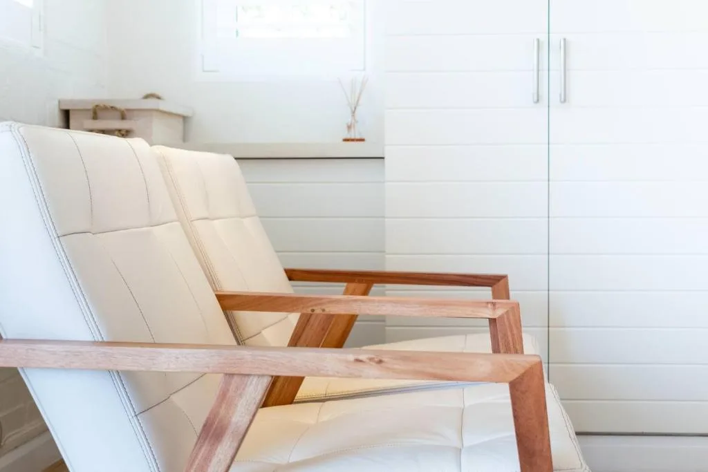 Modern cream upholstered chair with wooden frame and minimalist decor