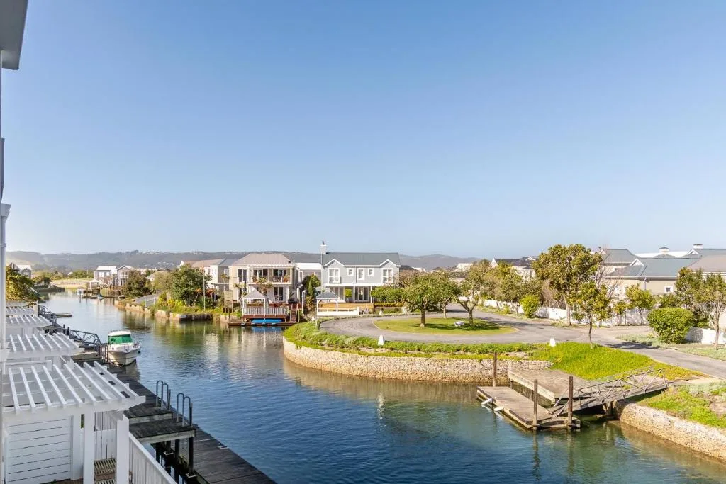 Scenic waterfront view of Thesen Islands canal with boats and residential homes