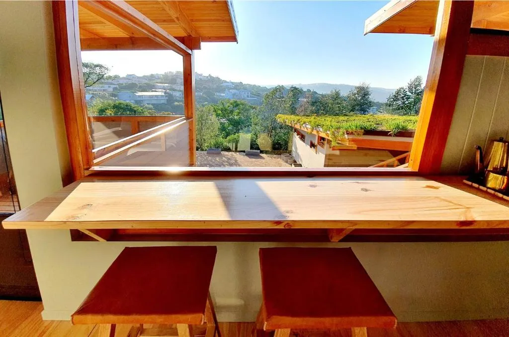 Wooden deck with mountain and vineyard views through open window