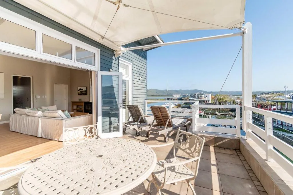 Spacious deck with loungers overlooking Knysna lagoon and mountains beyond