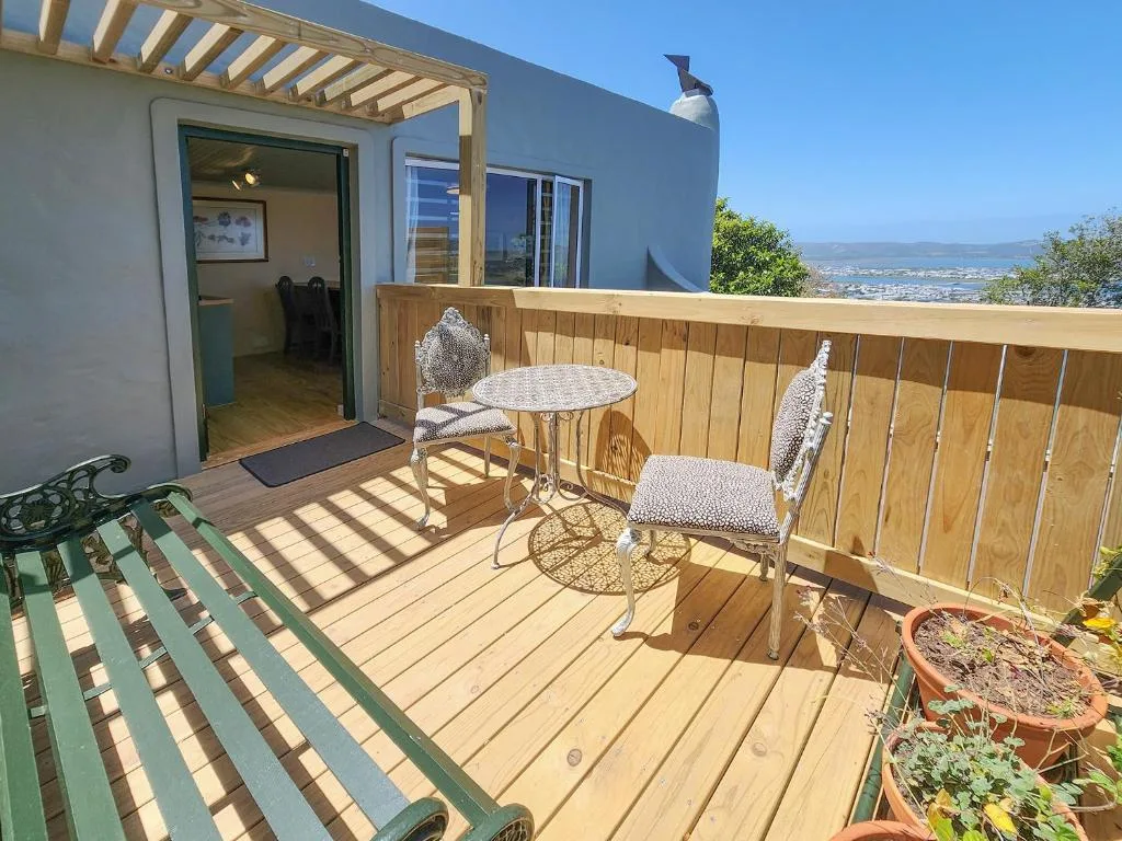 Wooden deck with seating area overlooking Knysna valley landscape