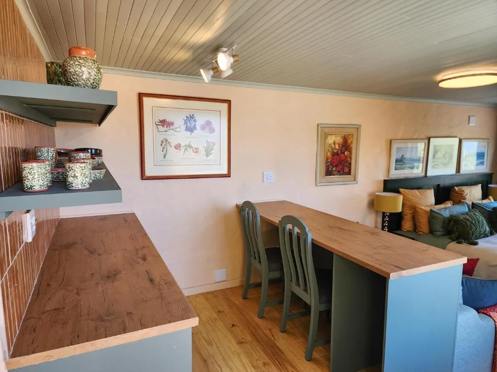 Open-plan kitchen and dining area with wooden countertops and seating