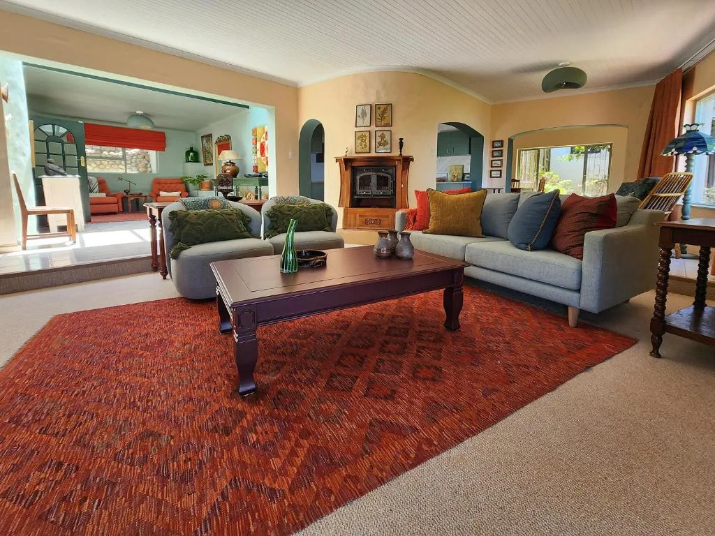 Spacious living room with grey sofas, wooden coffee table, and fireplace
