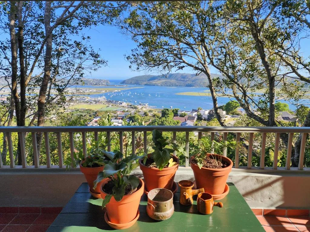 Knysna Lagoon vista from elevated deck with potted plants and railings