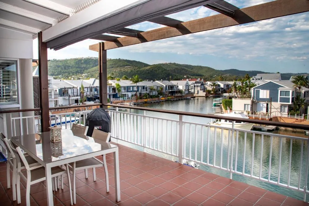 Waterfront deck with chairs overlooking lagoon and town buildings