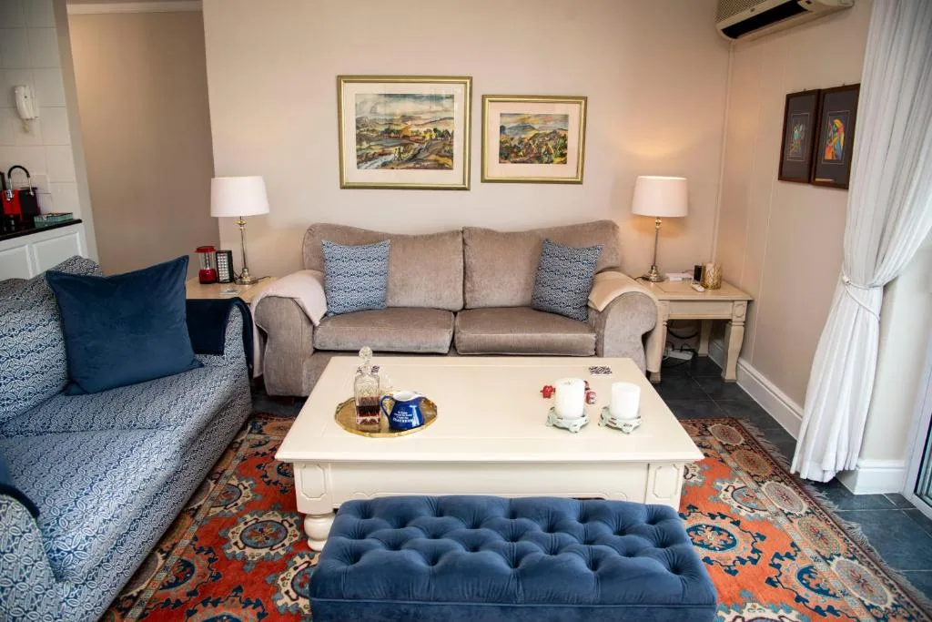 Elegant lounge with beige sofa, patterned armchairs, and white coffee table