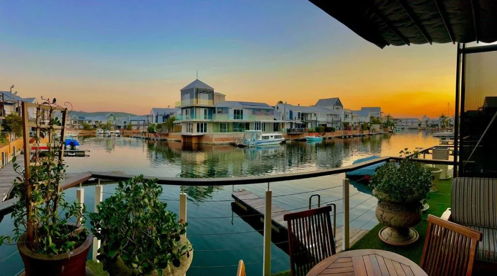 Waterfront deck at sunset with canal view and moored boats